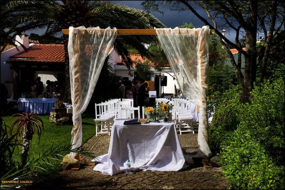 The wedding ceremony table, under a decorated arch at Morada do Sol in Sintra.