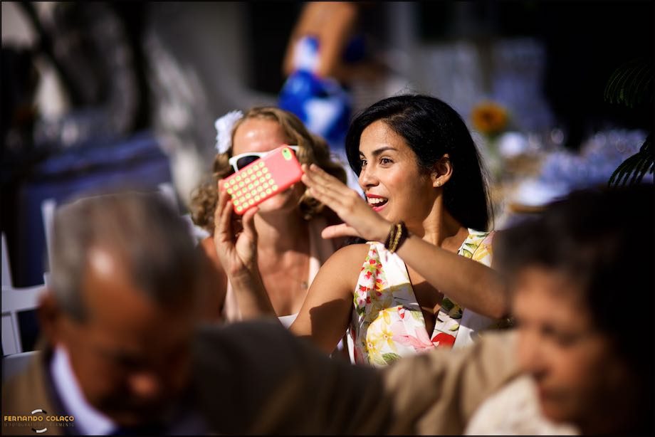 Wedding guests take a selfie before starting the wedding ceremony at Morada do Sol in Sintra.