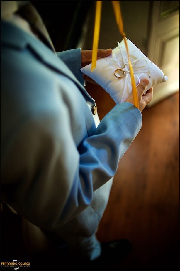 The wedding rings on a small pillow, in the hands of a boy who gives them to the bride and groom at the right moment of the wedding ceremony.