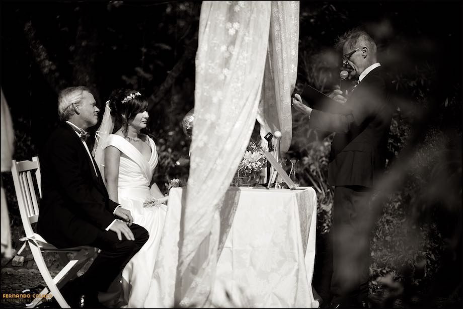 The bride and groom, at the wedding ceremony table, at Morada do Sol in Sintra, with the officiating conservator.