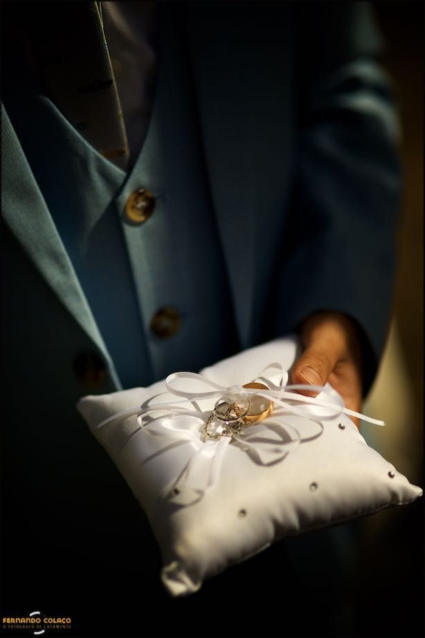 The wedding rings on a pillow in the hands of the bride's youngest son.