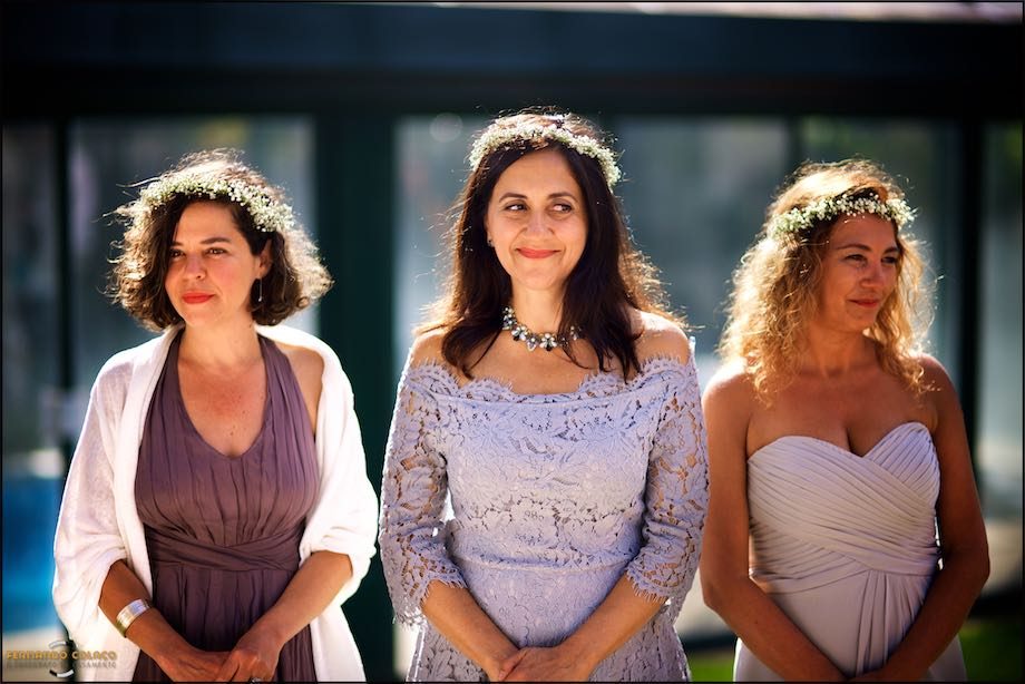 Three wedding guests as they watch the ceremony.