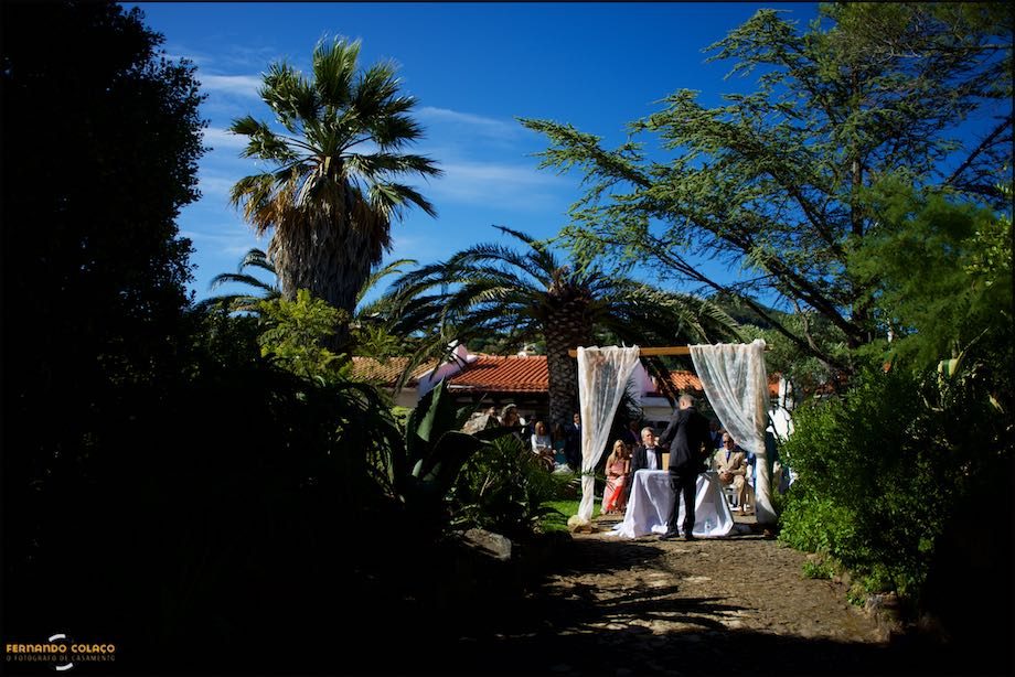 The wedding ceremony site seen from afar amidst the trees in the garden of Morada do Sol in Sintra.