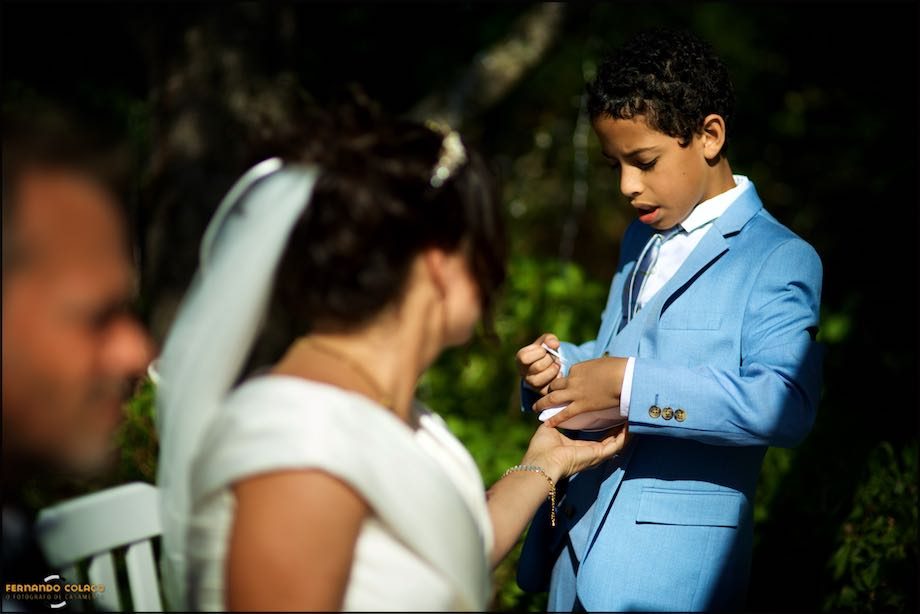 The bride's son delivers the rings for the wedding ceremony.