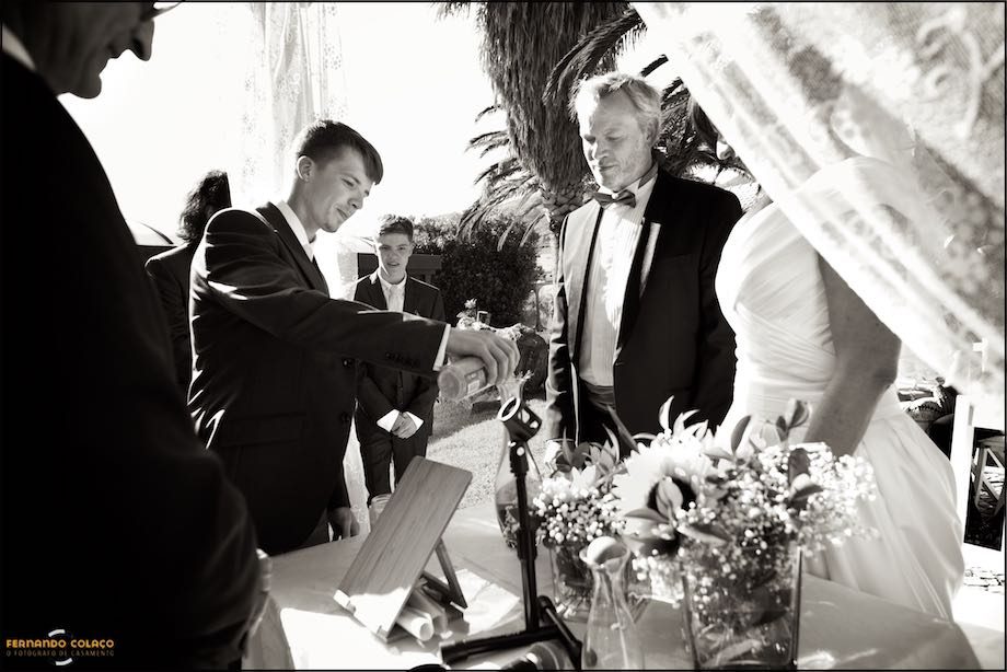 Son of the groom pours sand in a ritual of the wedding ceremony at Morada do Sol in Sintra.