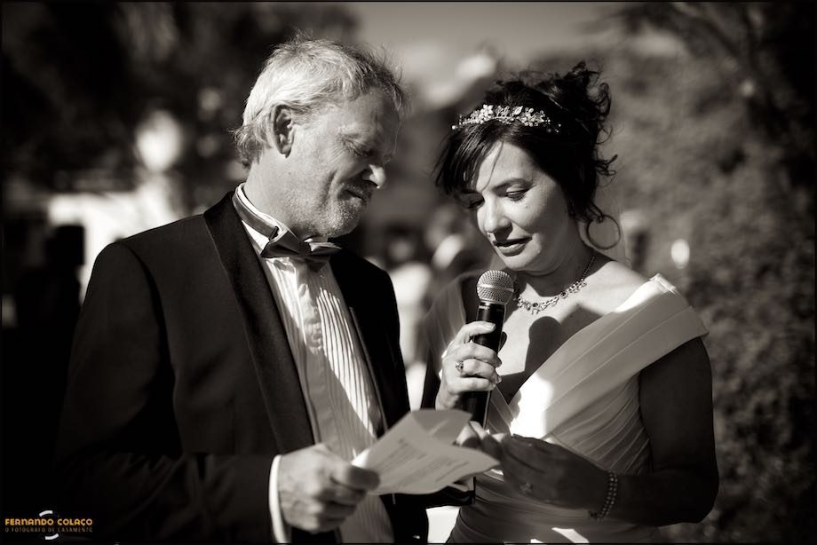 The bride reads the vows, next to the groom during the wedding ceremony.