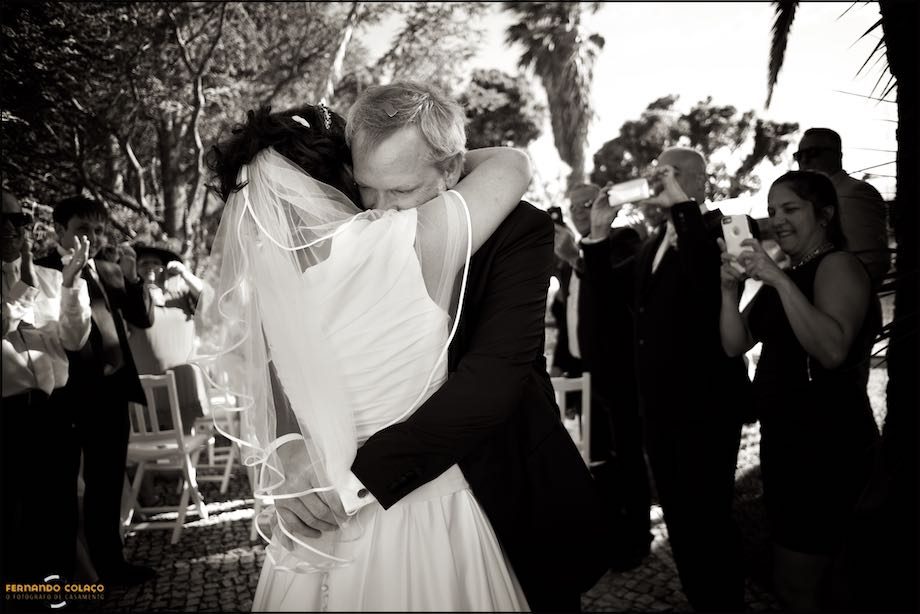 The bride and groom embrace each other with emotion at the end of the wedding ceremony.
