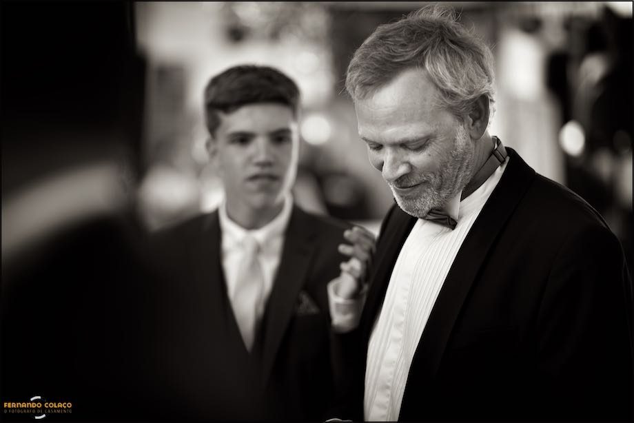 The emotional groom looks down as guests congratulate him on the wedding.