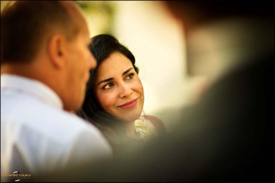A wedding guest smiles, alongside a friend during the wedding reception at Morada do Sol in Sintra.
