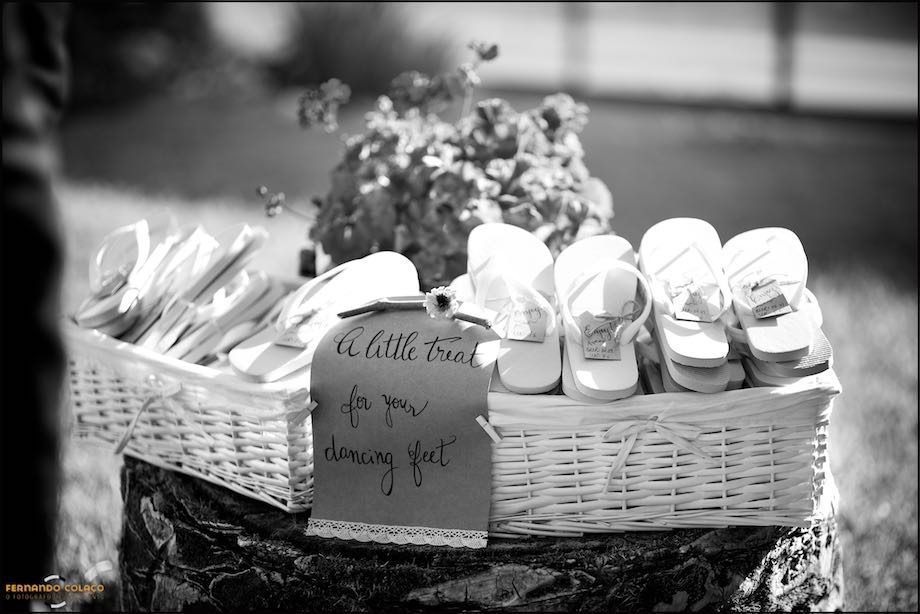 Two wicker baskets full of flip flops to offer to the wedding guests.
