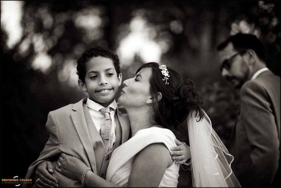The bride as she kisses her youngest son on the cheek.