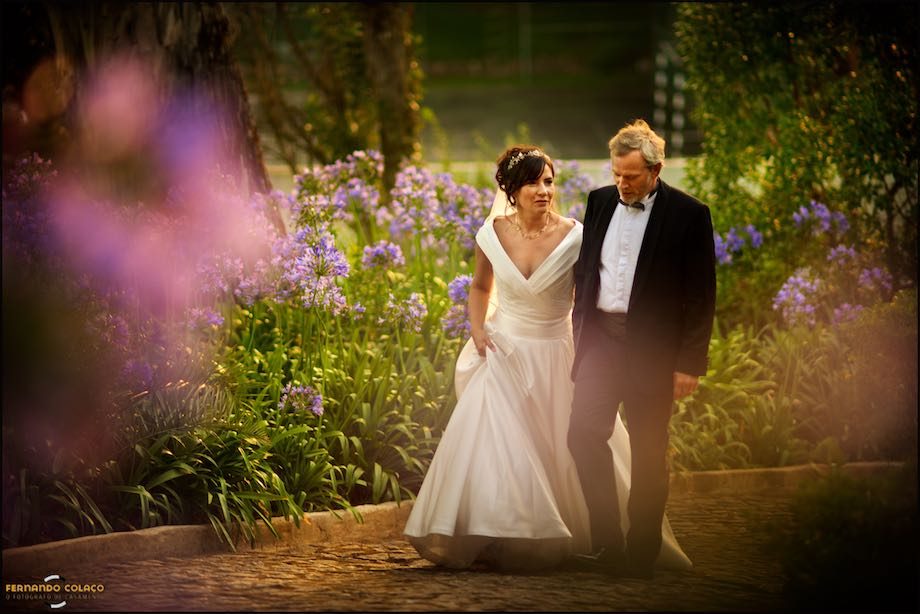 Among the flowers that line the path at Morada do Sol in Sintra, the bride and groom go up towards their guests.