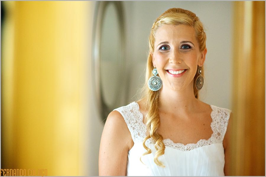 Portrait of the bride, smiling, with big round earrings.
