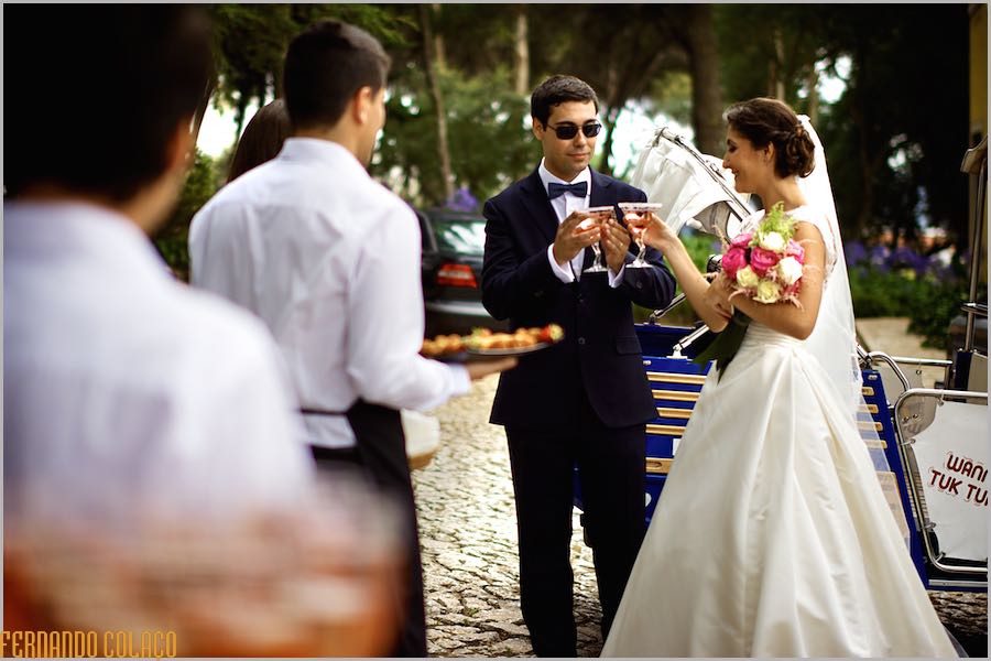 At Quinta do Lumarinho, the newlyweds with glasses of champagne in their hands celebrating at the reception.