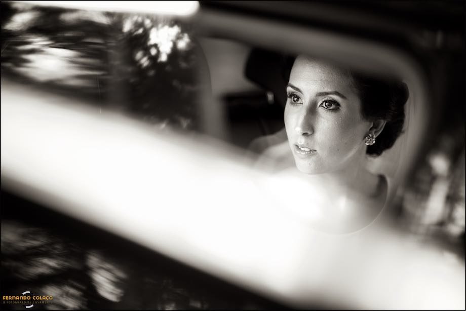 The bride looks out of the car as she approaches the wedding ceremony.