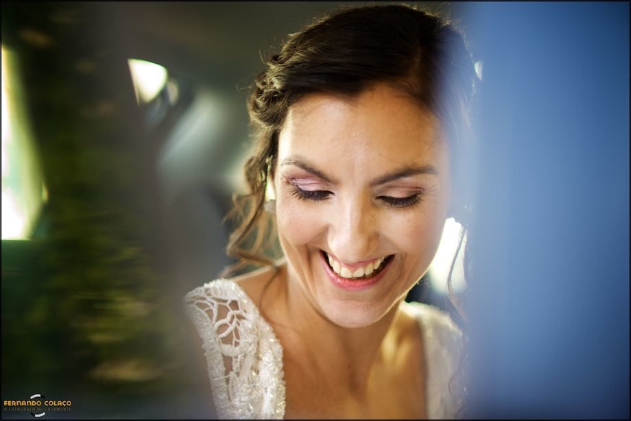 The bride laughing before getting out of the car for the wedding ceremony.
