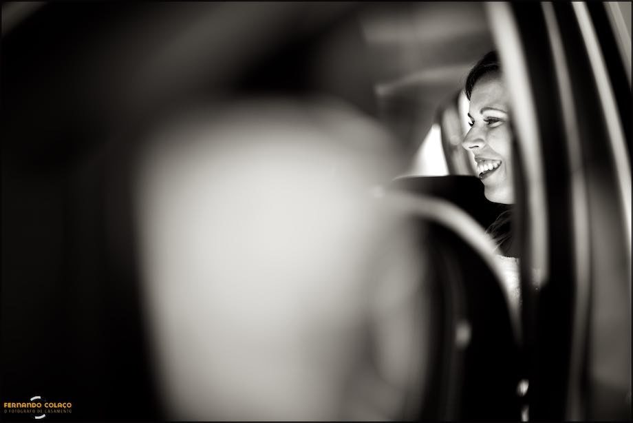 Profile of a smiling bride inside the car.