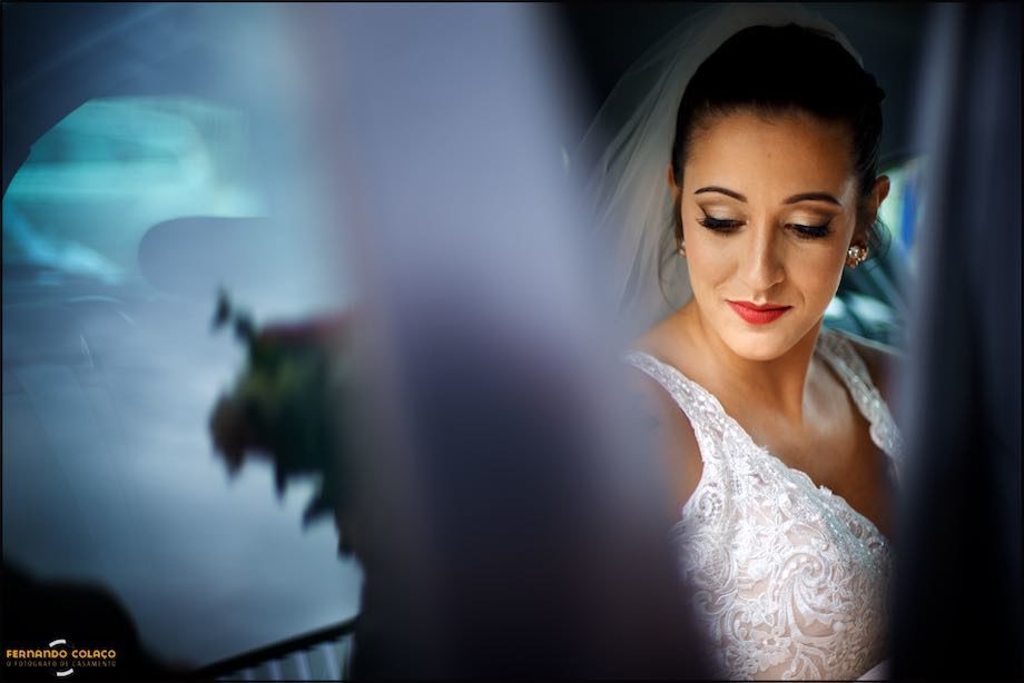Bride surrounded by the blue of the car.
