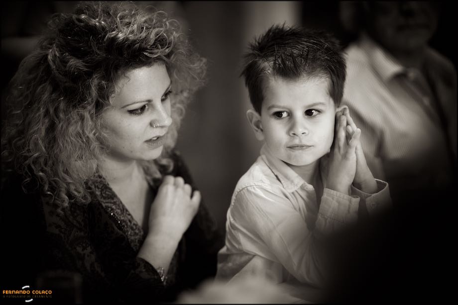 Boy listens very carefully to what his mother says at the wedding party.