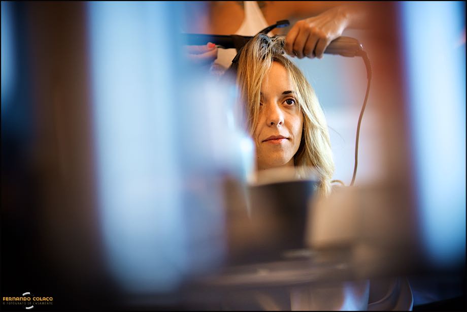 Head of the bride surrounded by out of focus when being hair dressed.