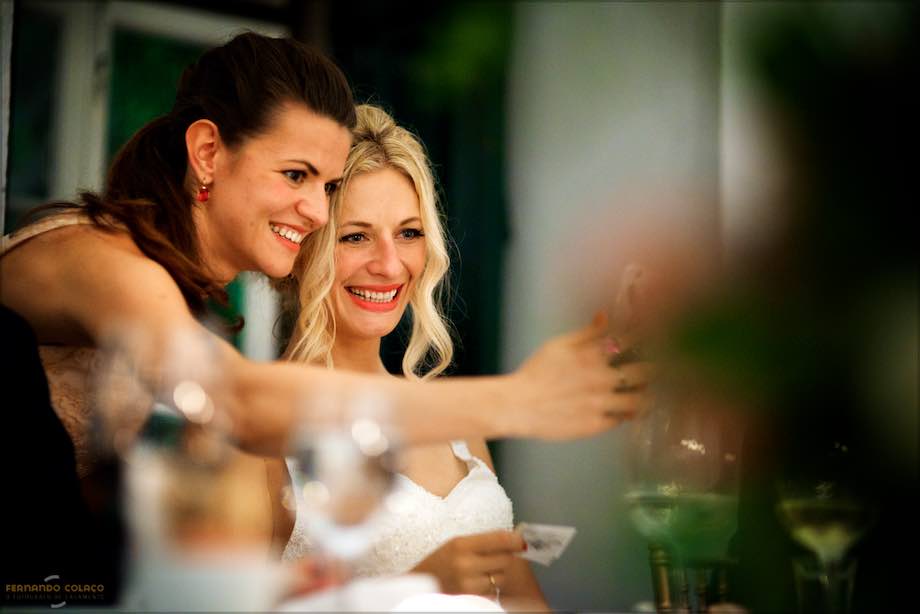 A wedding guest takes a selfie with the bride at Penha Longa Resort.