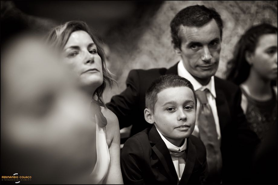 A little boy between his parents at the wedding ceremony.