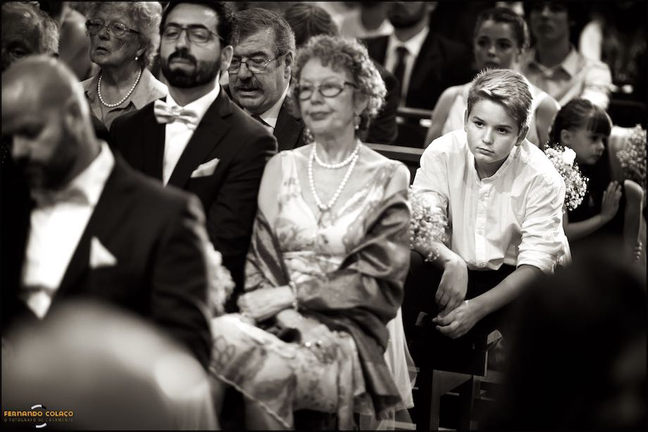Boy among the other guests paying attention to the wedding ceremony.