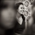 A woman guest, at the wedding ceremony, laughing, in a moment captured by the wedding photographer in Portugal.