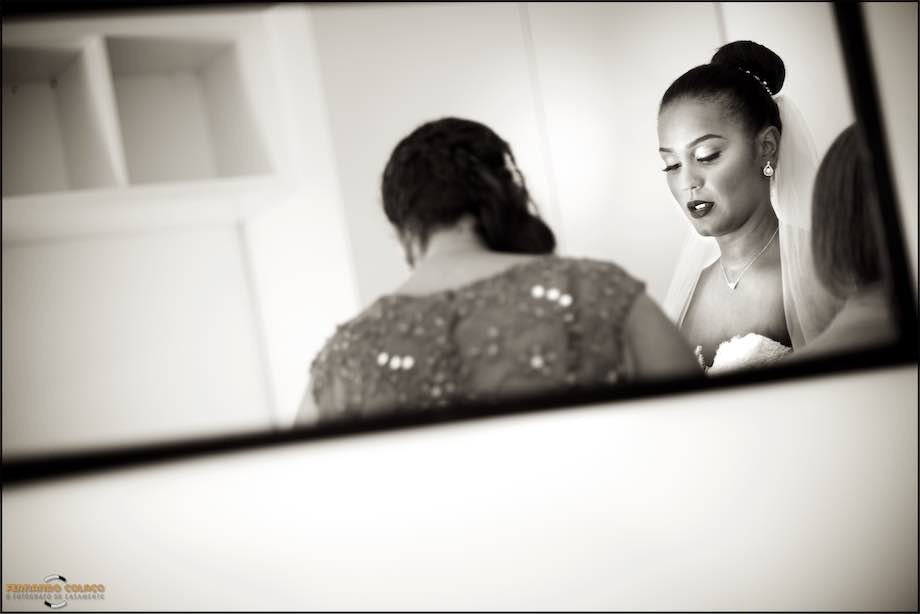 Bride in the mirror with attention to a detail.