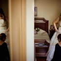 With a duplicated image in a mirror, the bride with her mother in the final adjustments of dressing the wedding dress, viewed by the Lisbon wedding photographer.