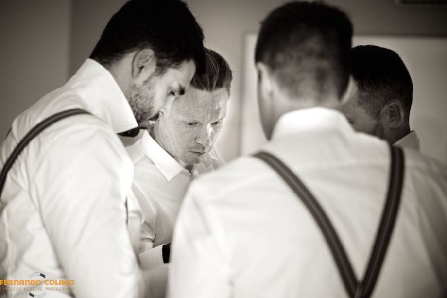 The groom in the midst of his three friends, as they dress for the wedding in Nazaré.