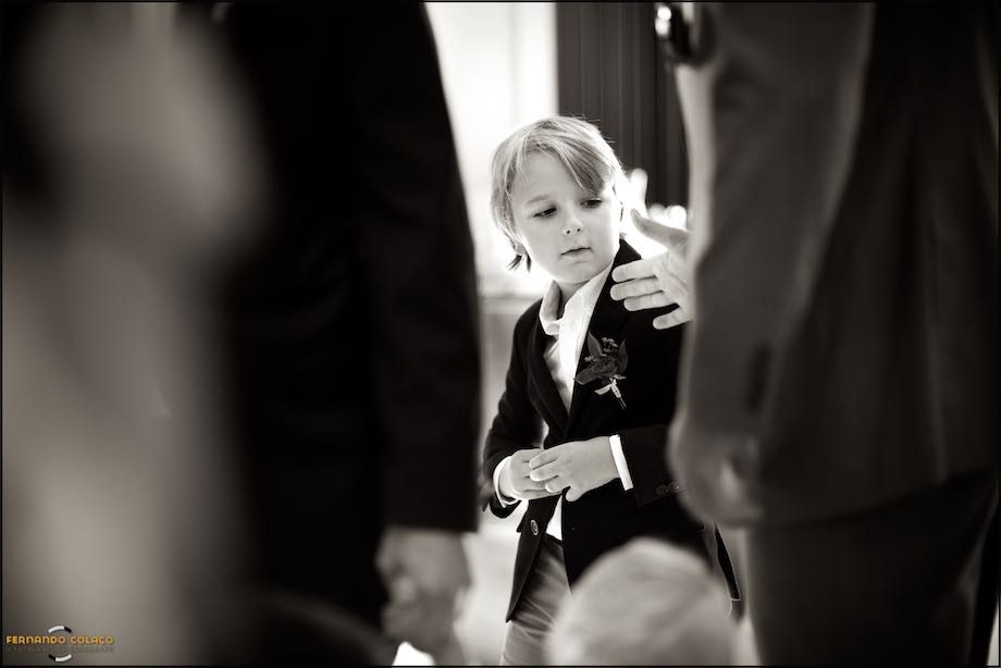 Filho dos noivos a abotoar o casaco.