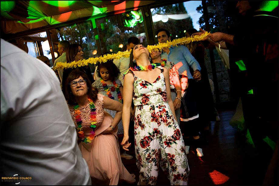 Convidadas no casamento durante a festa, passando por baixo de um arco.