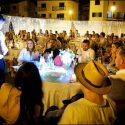 General view of tables with guests at a wedding in a square in Nazaré, by the wedding photographer.