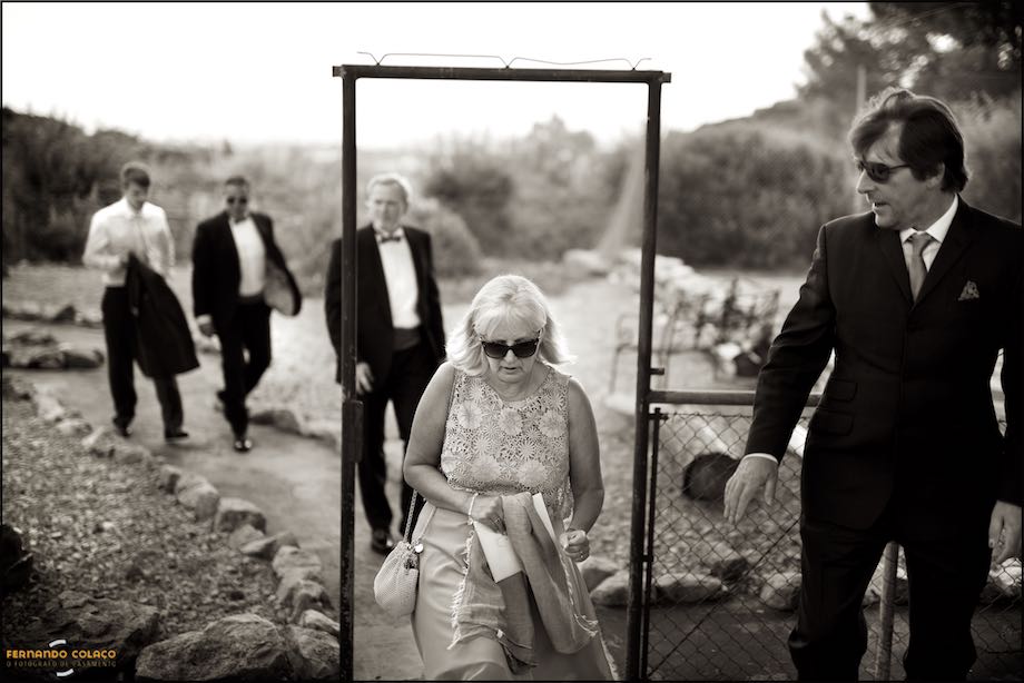 Wedding guests on the move to the ceremony location, followed by the wedding photographer in Portugal.