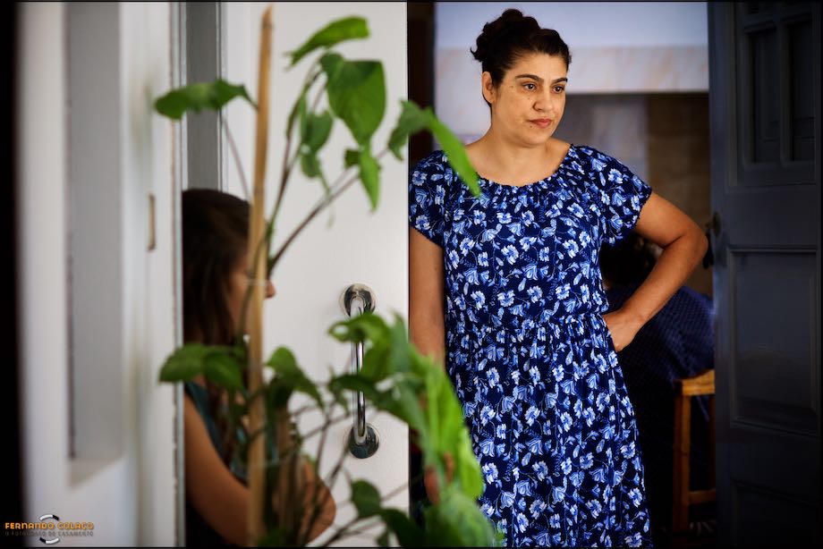 Mother of the bride observes the work in her daughter's hair.
