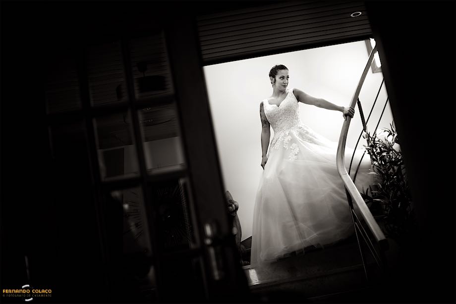 The bride descends the stairs to leave for the wedding ceremony.