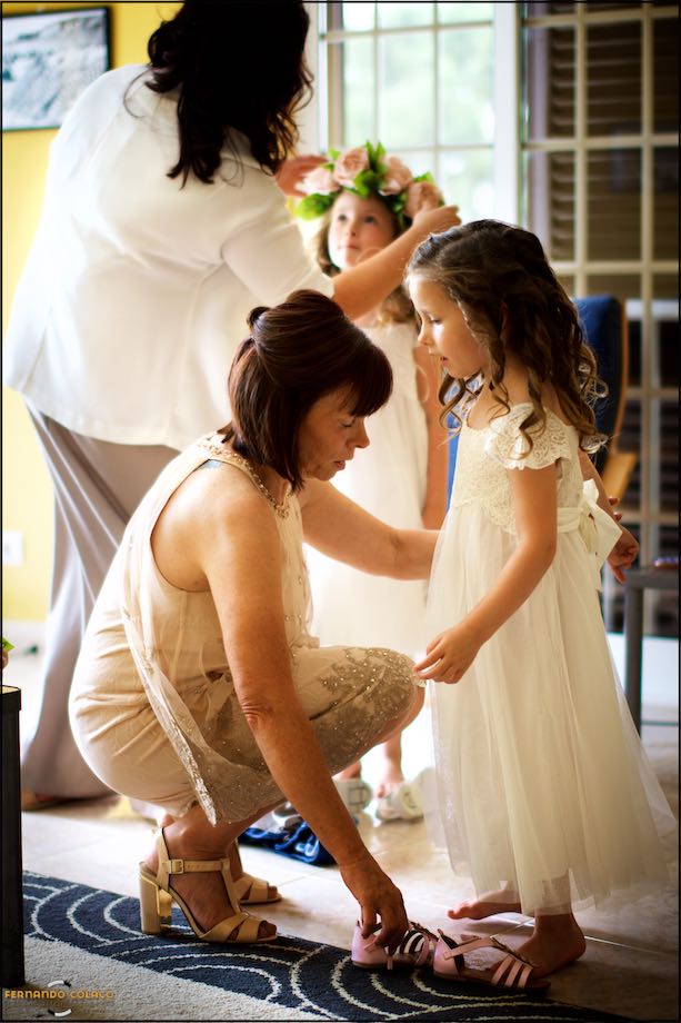 Little girls being prepared for the wedding by their mothers.