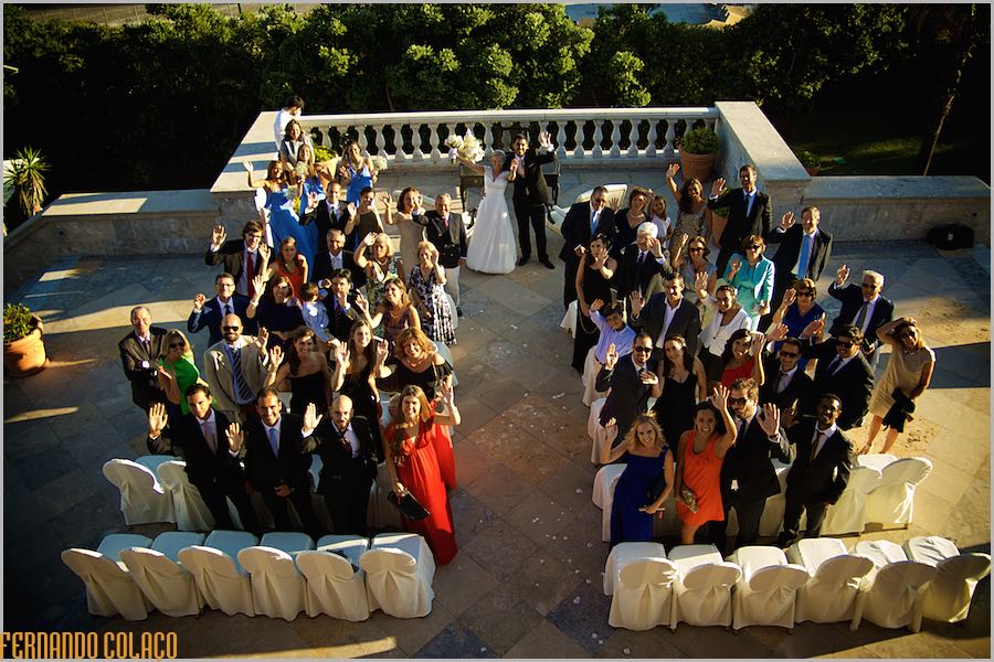 Bride and groom and wedding guests waving, seen from above at Grande Real Villa Itália Hotel & Spa.