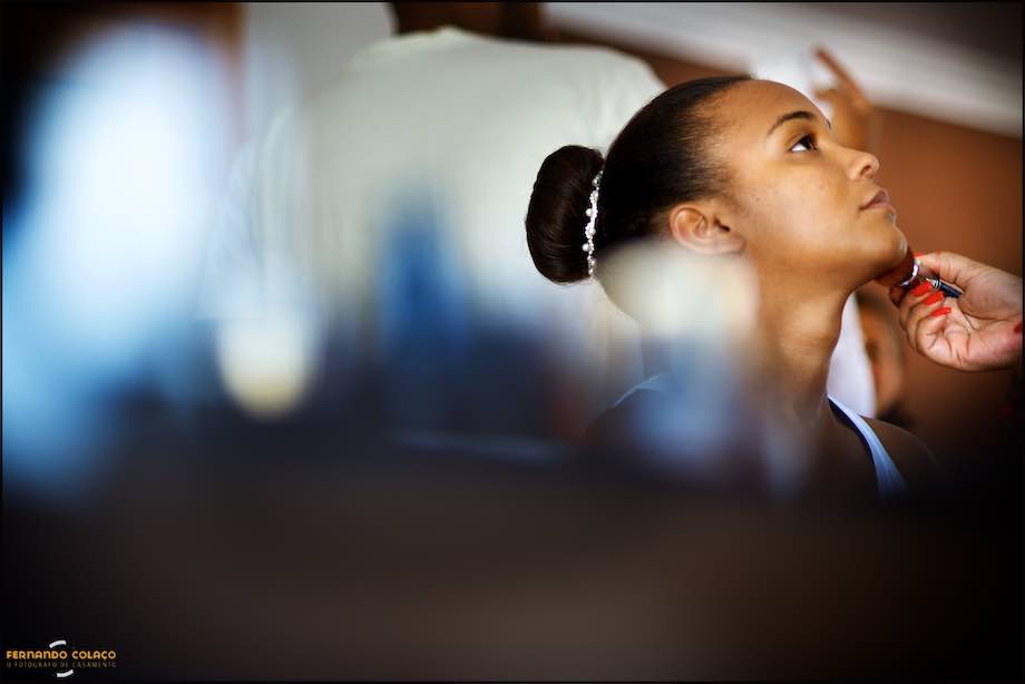Bride, between unfocused, being in the make up process.