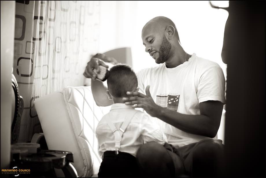 During the bride's preparation for the wedding, a father combs his little son.