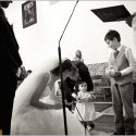 A little girl hands the rings to the bride, along with a boy, the groom and the priest at the ceremony at the Church of Nossa Sra. of the Assumption in Enxara do Bispo.