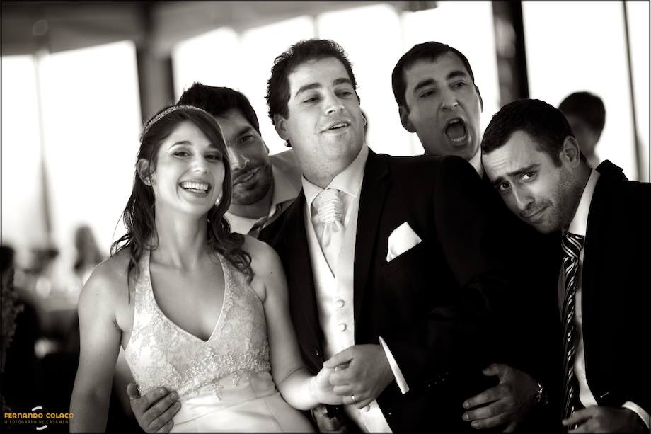 Bride in the lap of the groom and laughing.