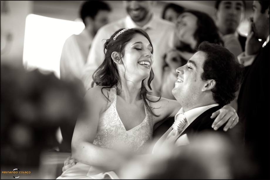 Friends of the couple laughing in the party of the wedding at Quinta de Nossa Senhora da Serra in Sintra, Portugal.