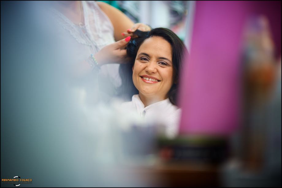 Face of the bride smiling, at the hairdresser, captured by the wedding photographer in Lisbon.