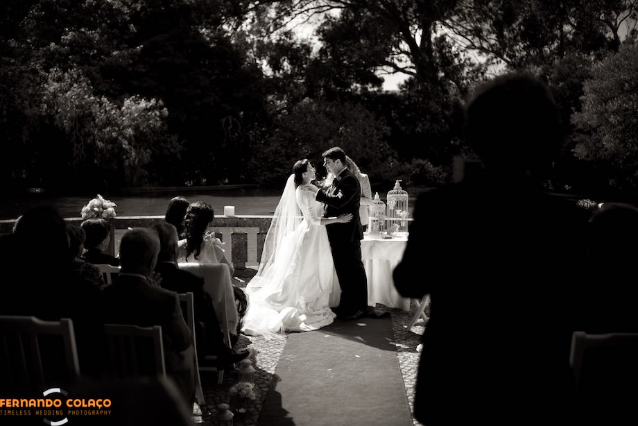 The groom and the bride facing each other as the wedding ceremony at Quinta da Serra ends.