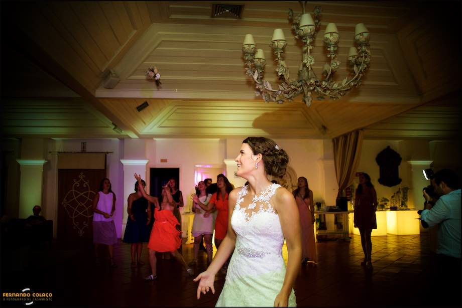 Bride throws her bouquet to the single ladies at the wedding.