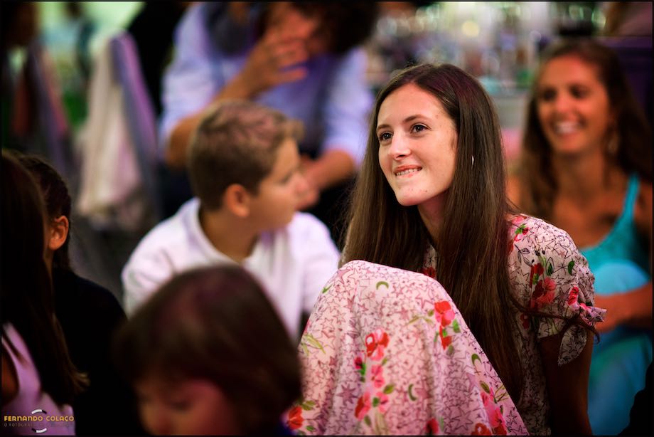 Wedding guests sitting in the dining room at Quinta da Cascata, seen through a mirror on the wall.