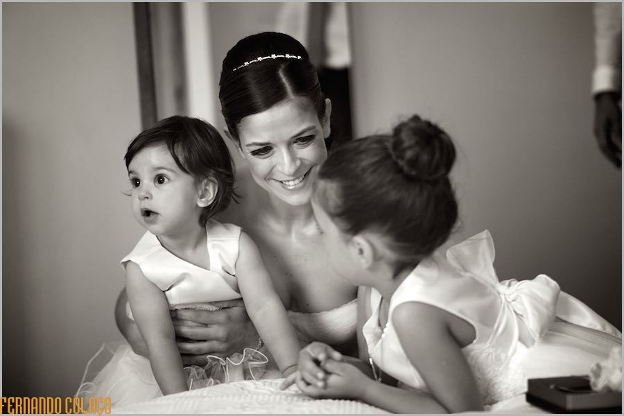 The bride, and mother of the two girls, playing with them before departing for the ceremony, viewed by the wedding photographer in Lisbon.