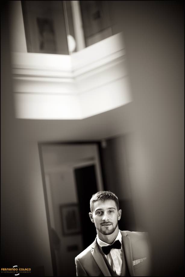 The groom poses after ready.